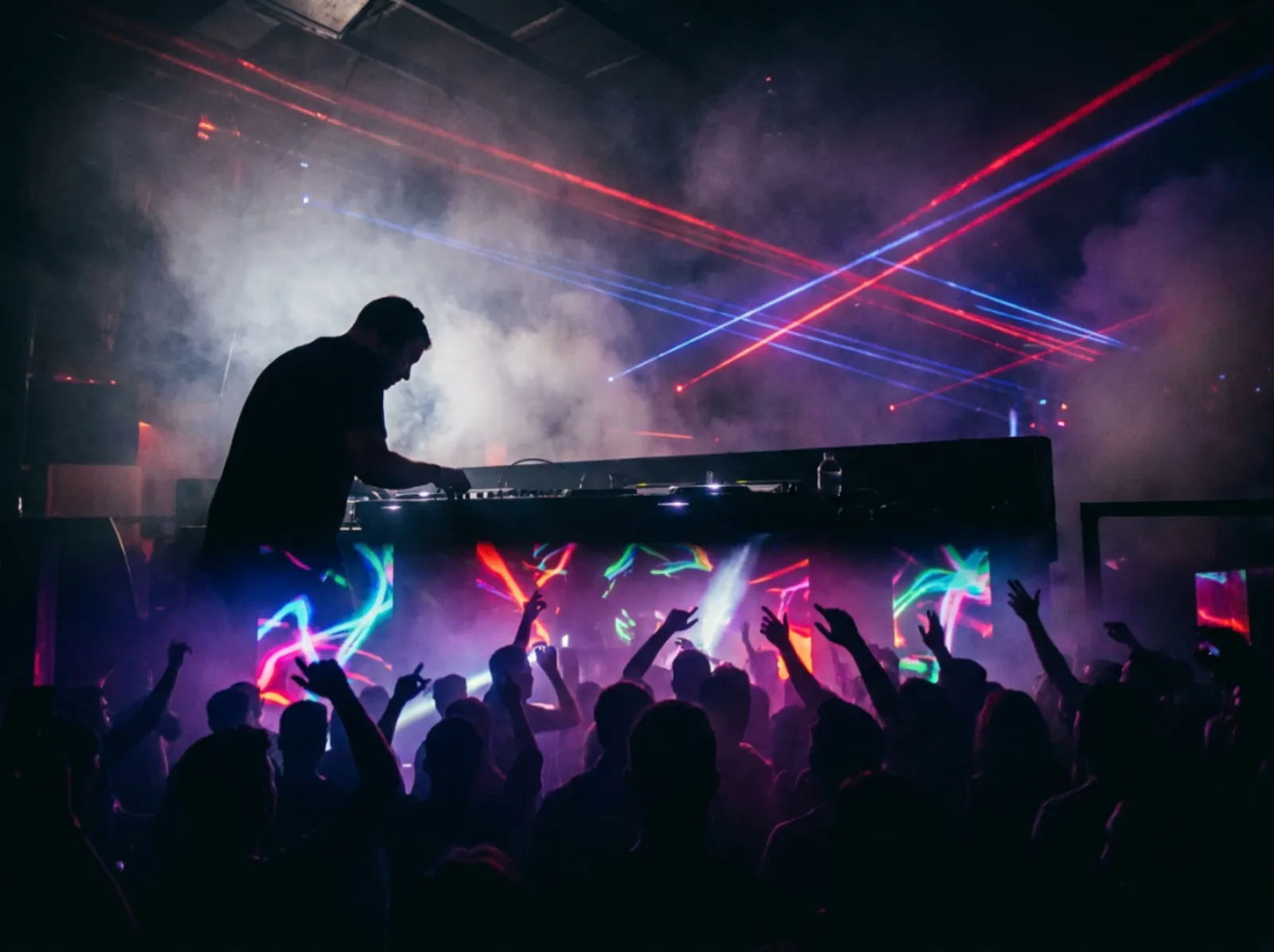 Club DJ silhouette with red and blue laser beams