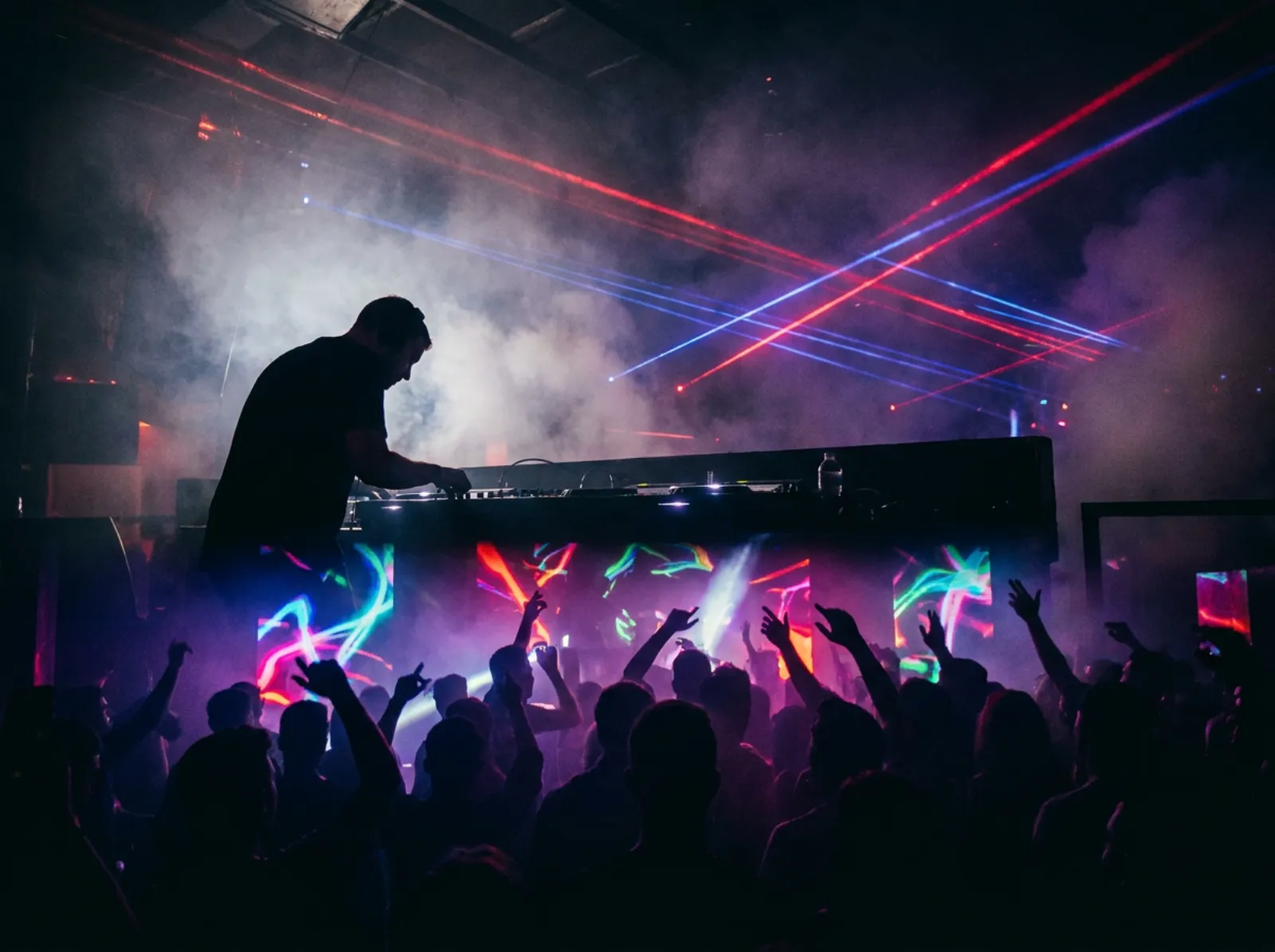 Club DJ silhouette with red and blue laser beams