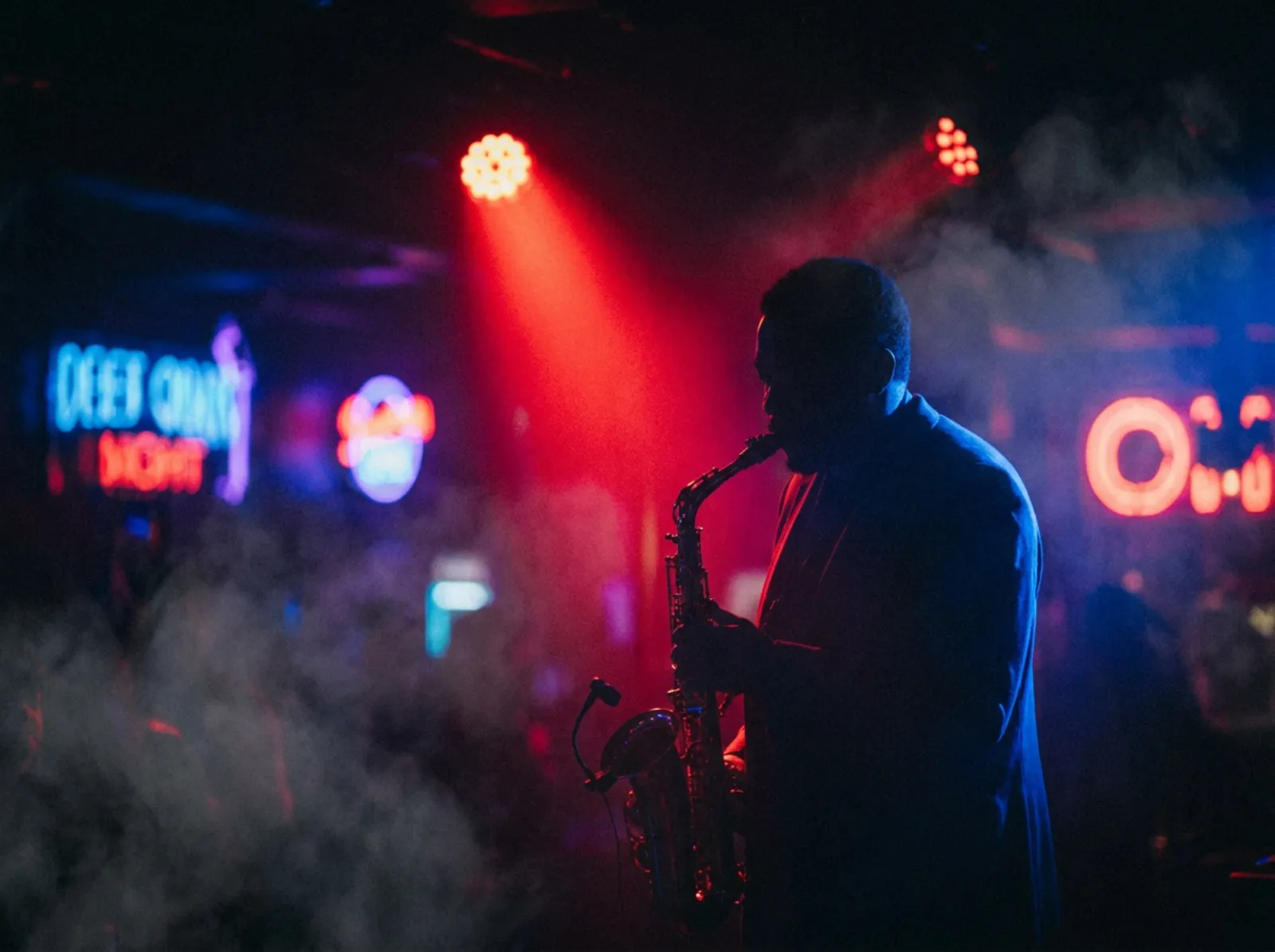 Saxophonist under a red spotlight and blue rim light
