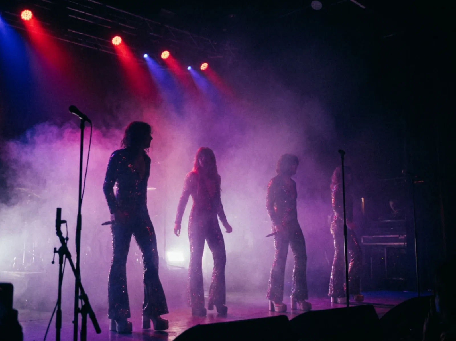 Disco tribute quartet under red and blue spotlights