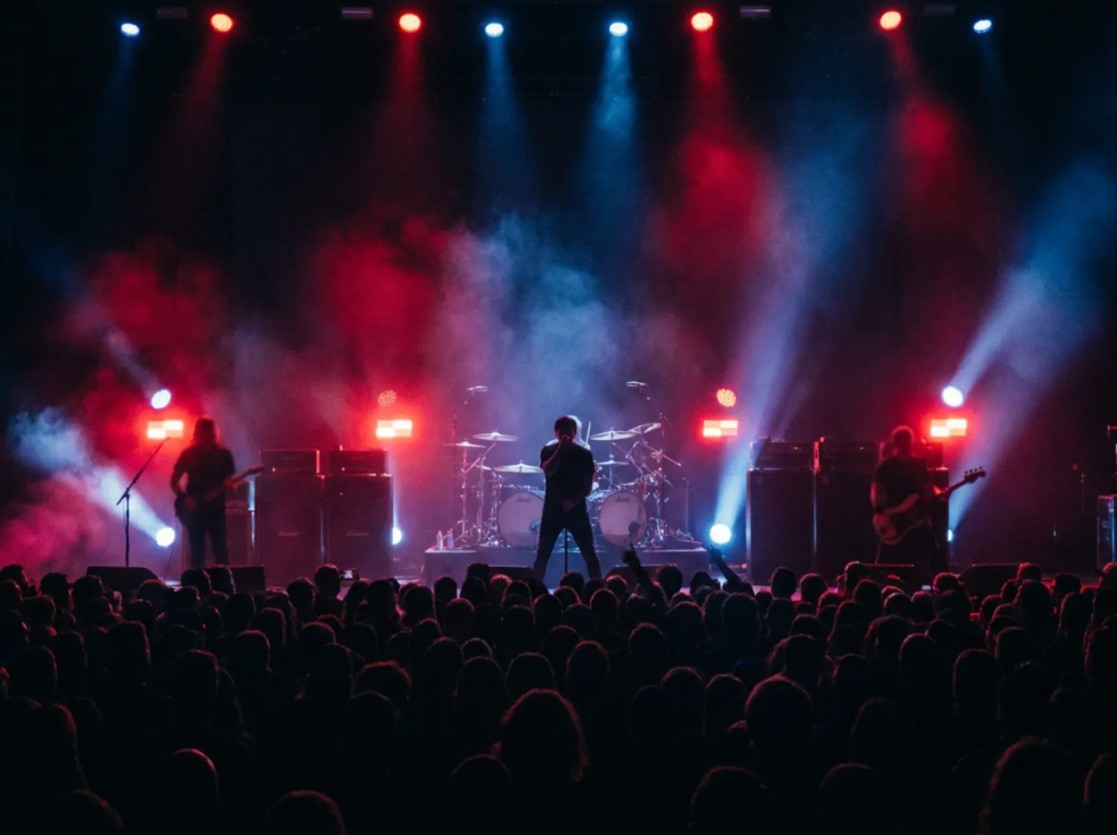 Rock tribute band under dramatic red and blue lighting